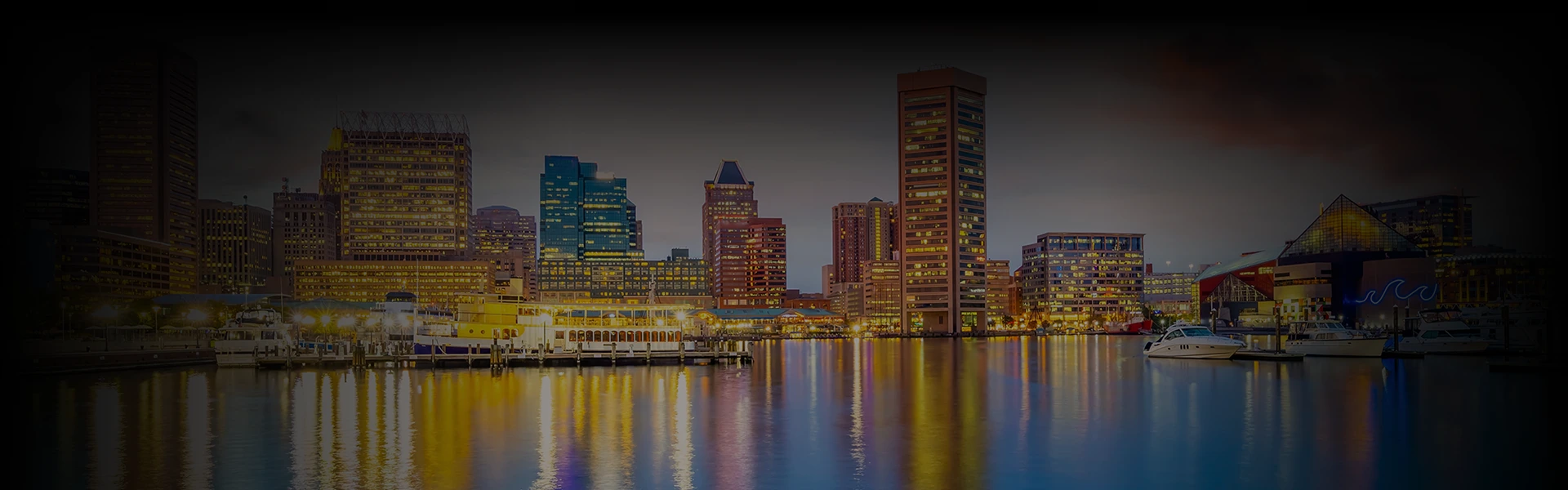 Baltimore's waterfront skyline at dusk with glowing buildings and yachts, overlaid with 'Washington DC to Baltimore Car Service' highlighting luxury travel between cities.