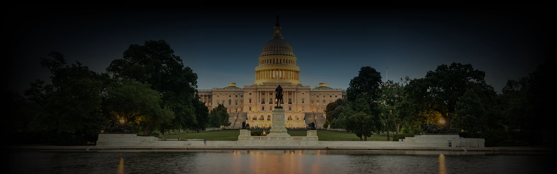 Evening view of the U.S. Capitol in Washington DC with a statue in the foreground and tree-lined paths, symbolizing the elegance and prestige of car service in Washington DC.